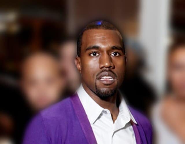 A man in a purple jacket and white shirt stands indoors with a blurred background, exuding the confident demeanor of a Los Angeles employment attorney. Employee Rights>Wrongful Termination