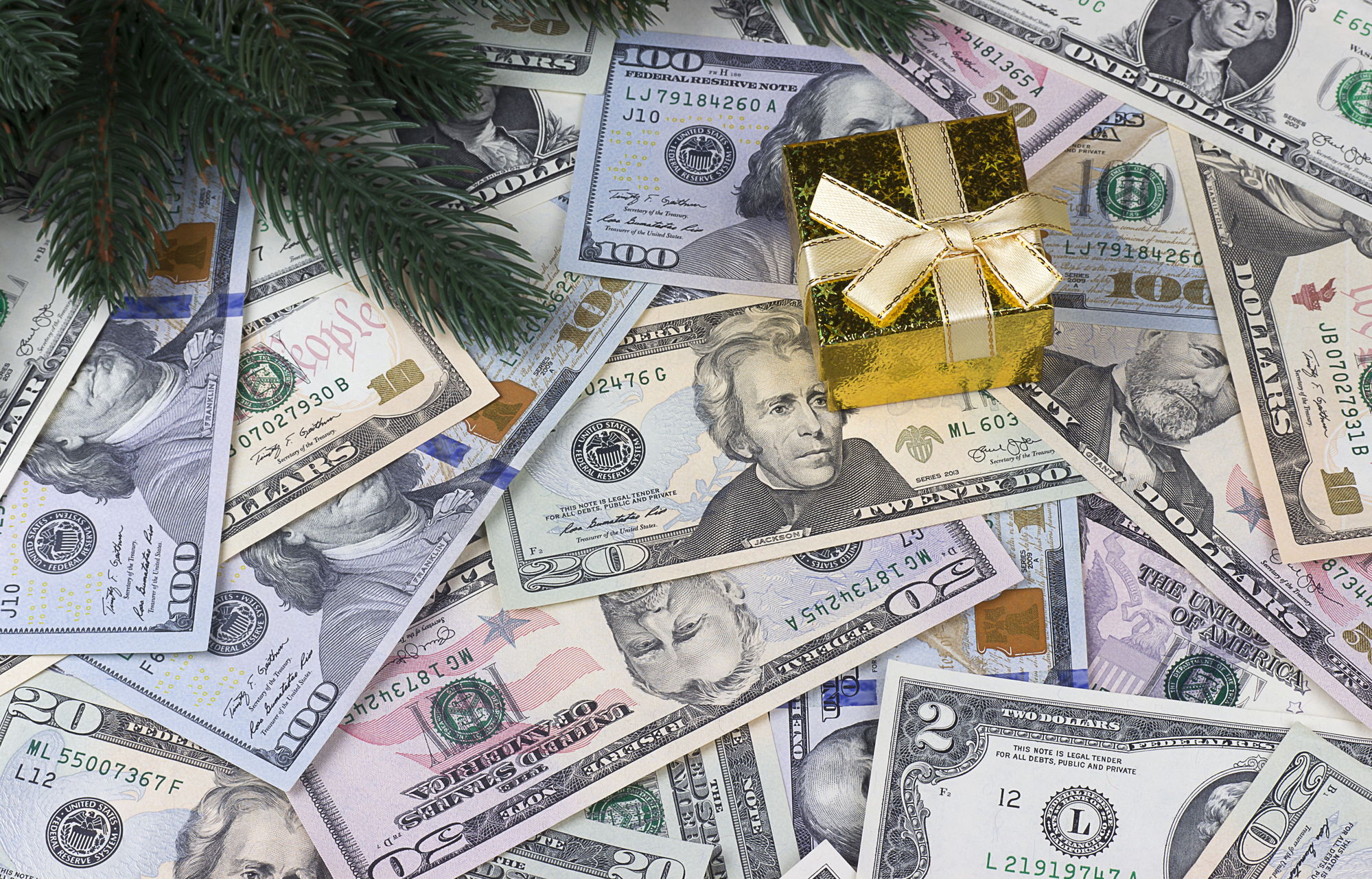 One hundred US dollar bills with gift boxes and Christmas decoration Employment Law