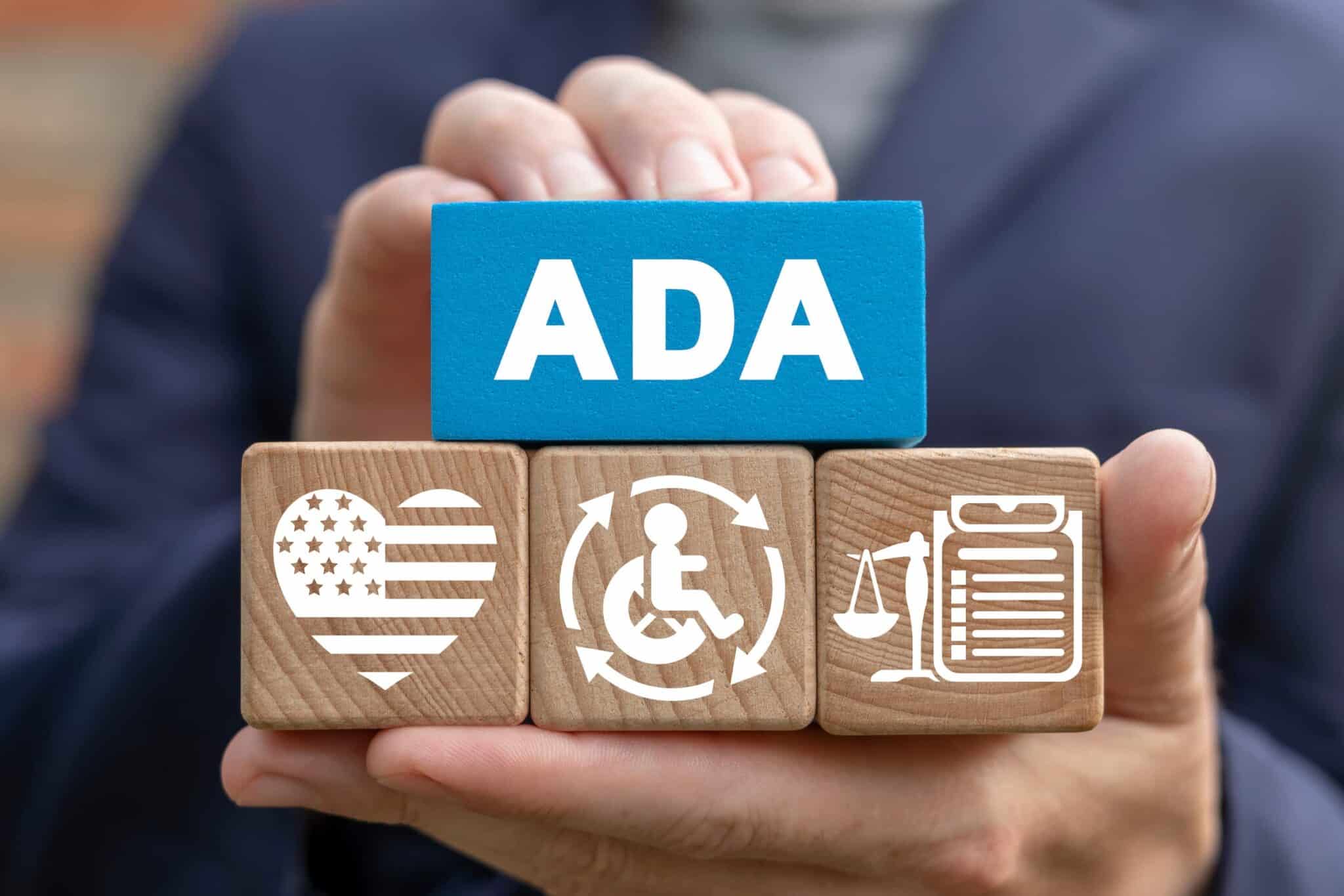Hands hold a blue block labeled "ADA" above three wooden blocks with symbols of a heart with stripes, disability icon, and justice scales, reflecting the dedication of a Los Angeles employment lawyer to advocating for fairness and accessibility in the workplace. Employee Rights>Workplace Discrimination